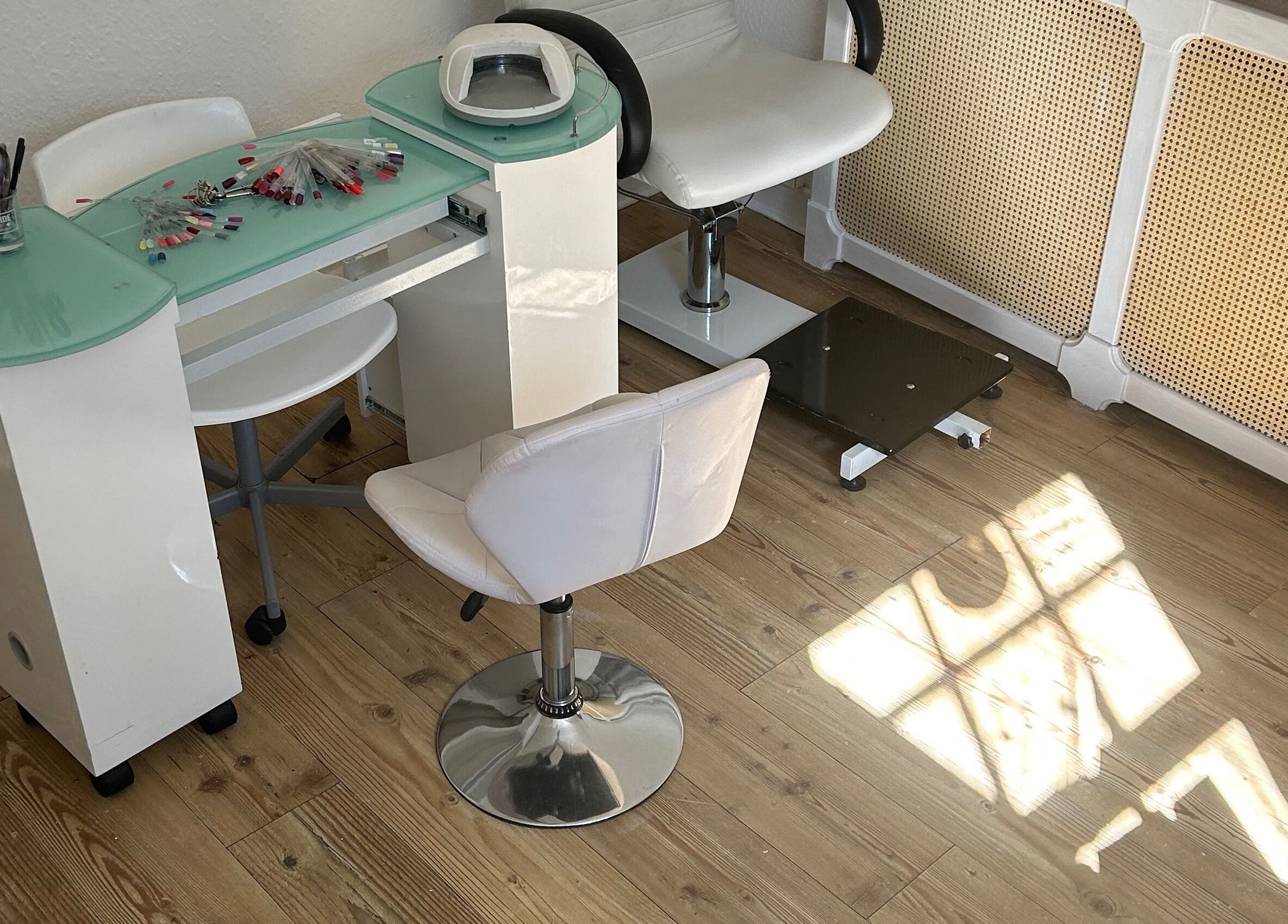 Chic nail station setup at Beauty Worx, Taunton, England, GB, featuring stylish chairs and manicure tools.