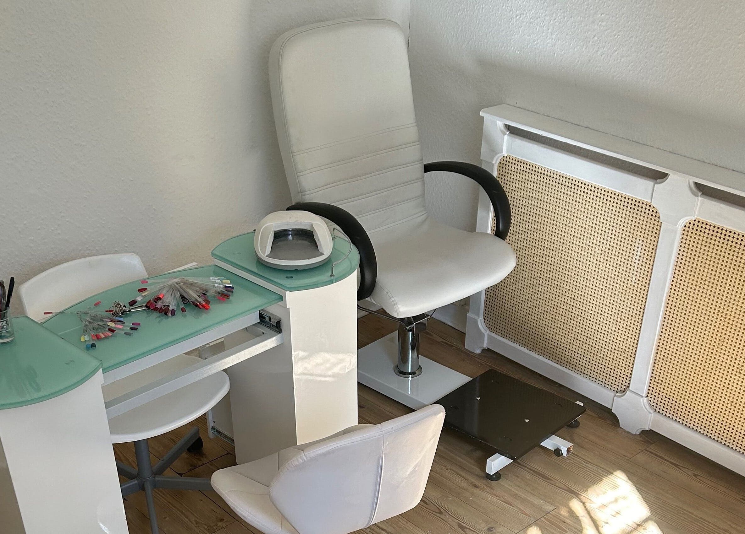 Modern nail station at Beauty Worx, Taunton, England, GB, featuring stylish white and glass decor.