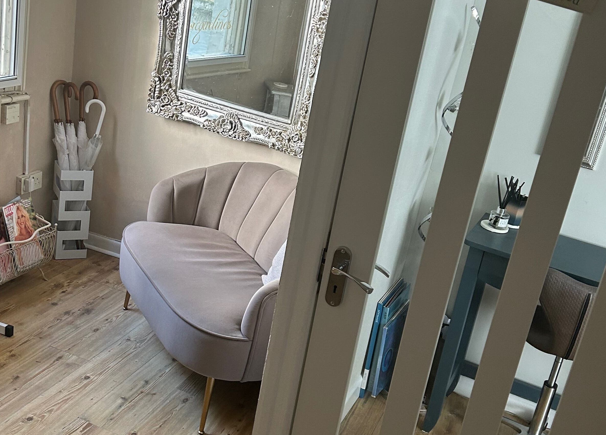 Chic beauty corner at Beauty Worx, Taunton, England, GB with sofa, magazines, and elegant decor.