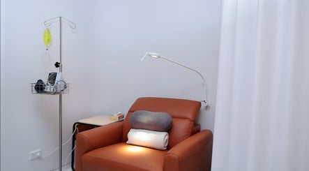 Relaxing treatment room at Internal Clinic in Chatswood, New South Wales, AU, featuring a cozy recliner and IV stand.