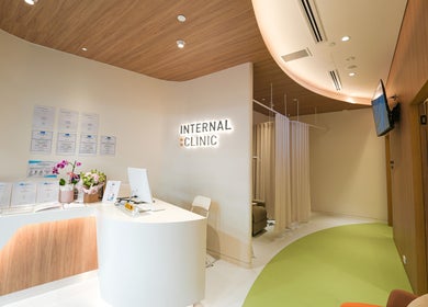 Reception area of Internal Clinic, Chatswood, New South Wales, AU, featuring a modern desk and welcoming signs.