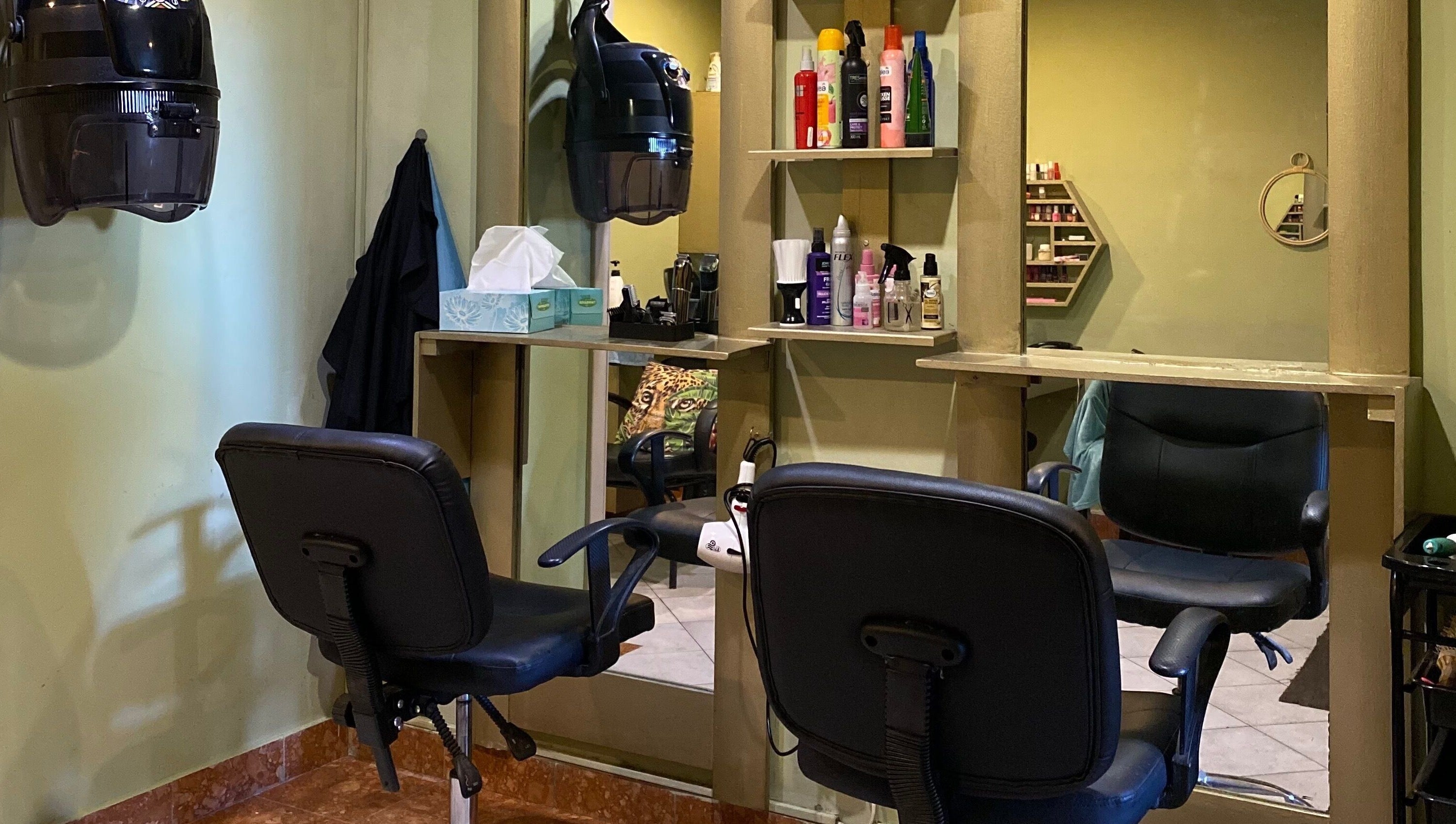 Cozy styling area at Salon Tossy Hair and Body, Windhoek, Khomas Region, NA, with chairs and hair care products.