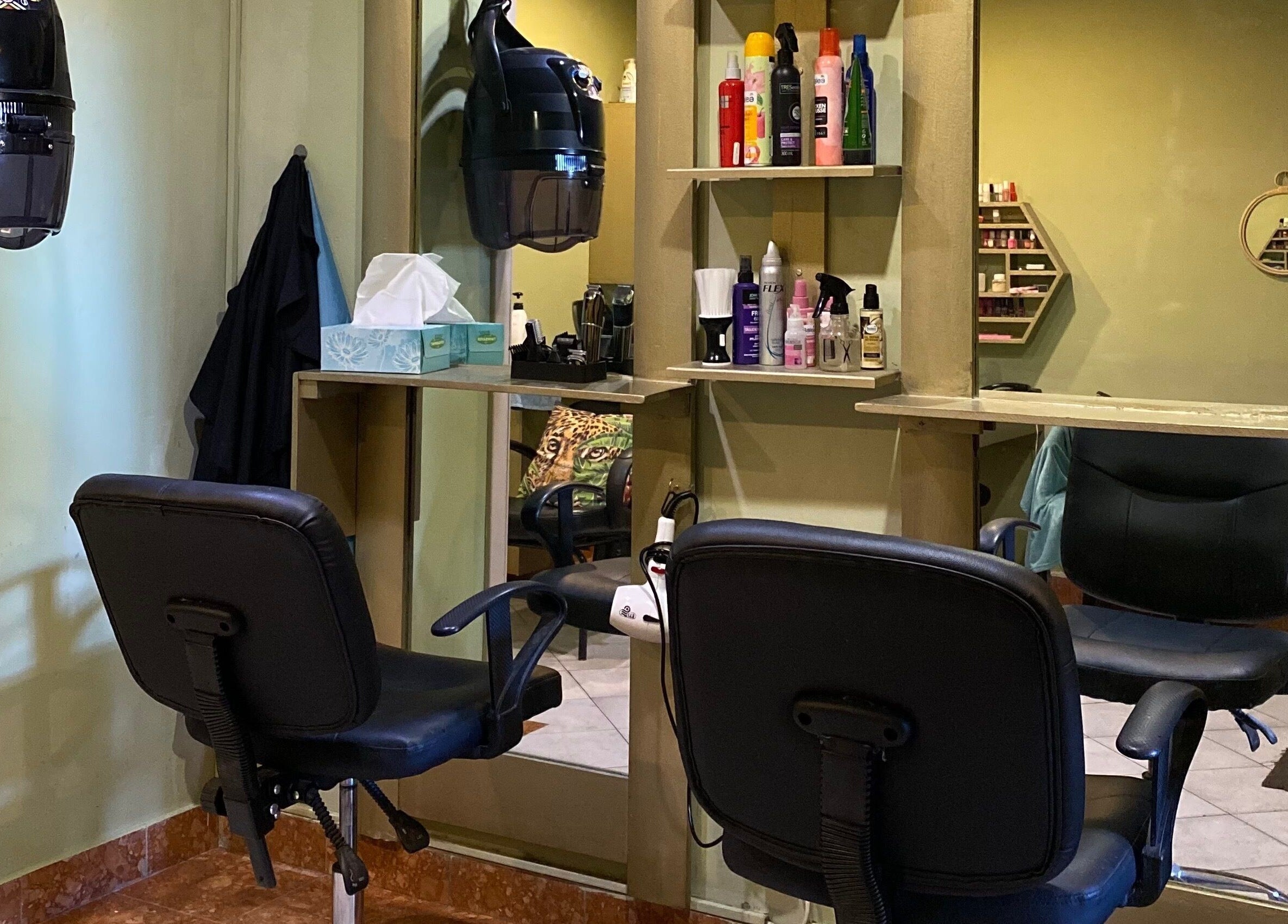 Cozy styling area at Salon Tossy Hair and Body, Windhoek, Khomas Region, NA, with chairs and hair care products.