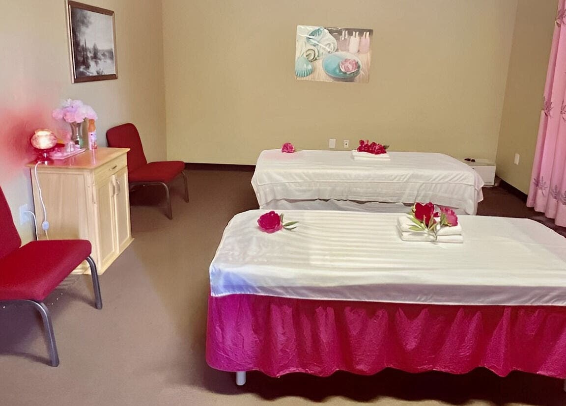 Relaxing massage room at Spring Sunny Spa, Chesapeake, Virginia, US, featuring twin tables and calming decor.