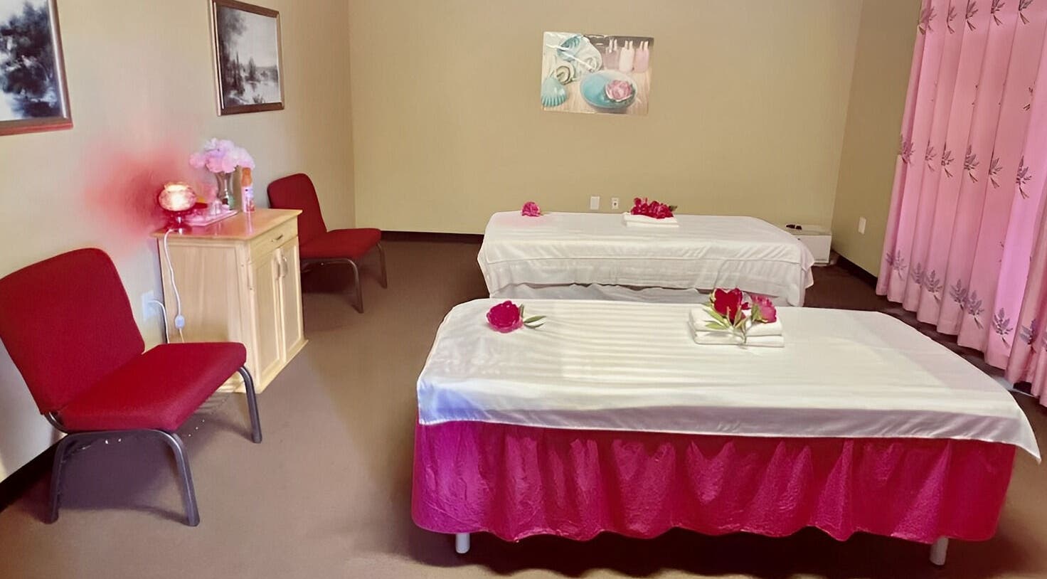 Relaxing massage room at Spring Sunny Spa, Chesapeake, Virginia, US, featuring twin tables and calming decor.