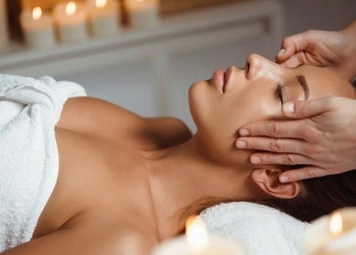 Relaxing head massage at Shape & Slim Massage Studio in Leicester, England, GB surrounded by ambient candles.