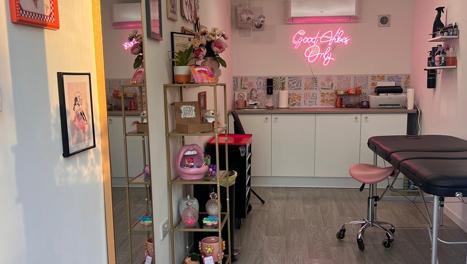 Chloe Duncan Tattoo studio in Rochester, England, GB with modern decor and vibrant neon sign.