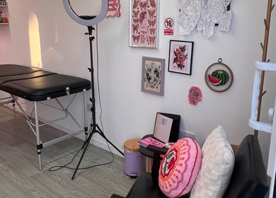 Bright tattoo studio interior at Chloe Duncan Tattoo, Rochester, England, GB. Features art and equipment.