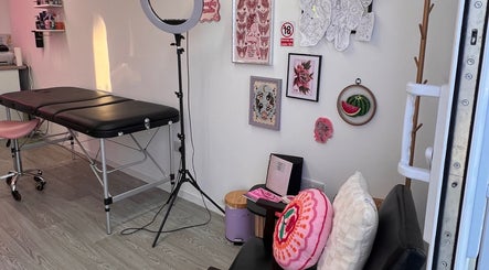 Bright tattoo studio interior at Chloe Duncan Tattoo, Rochester, England, GB. Features art and equipment.