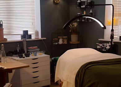 Relaxing treatment room at The Pampered Cow, Hixon, England, GB, featuring a massage table and calm ambiance.