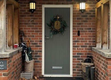 Charming entrance of The Pampered Cow in Hixon, England, GB displaying a decorated door and rustic decor.