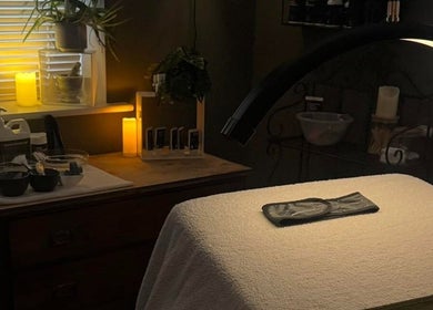 Tranquil spa room at The Pampered Cow, Hixon, England, GB, featuring a massage table and soothing candlelight.