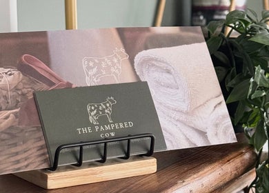 Cozy spa setup at The Pampered Cow, Hixon, England, GB with towels and plants for a relaxing ambiance.