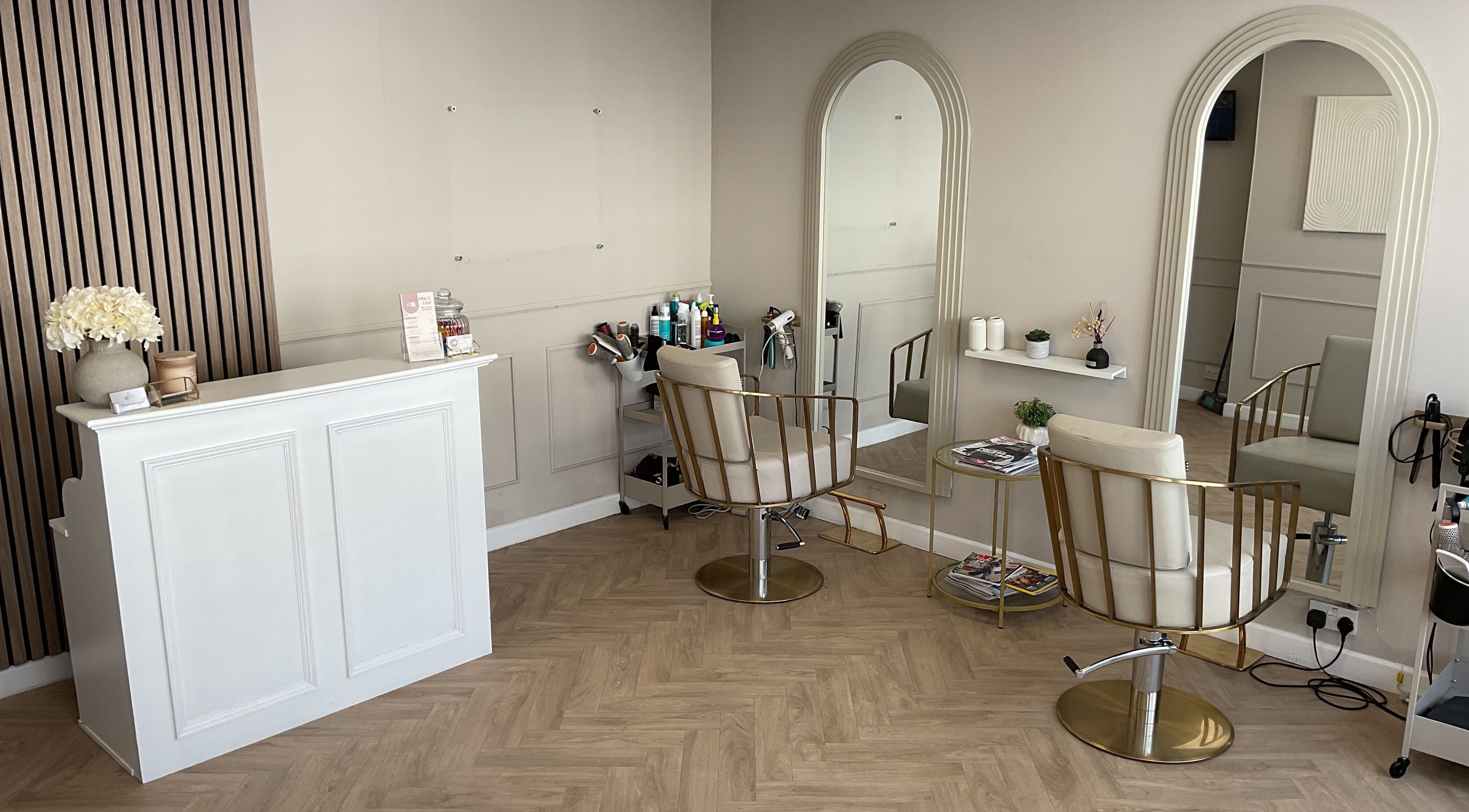 Elegant salon interior at Paris James Hairstylist, Newton Abbot, England, GB with modern chairs and mirrors.