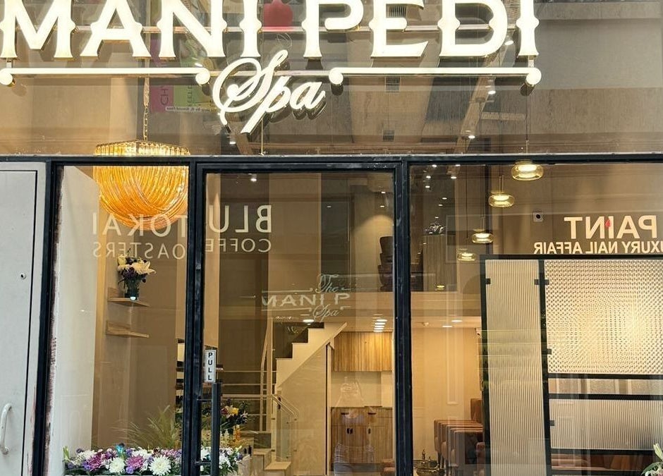 Front view of The Mani Pedi Spa, AIPL Joy Street in Gurugram, Haryana, IN. Elegant signage and lit interior.