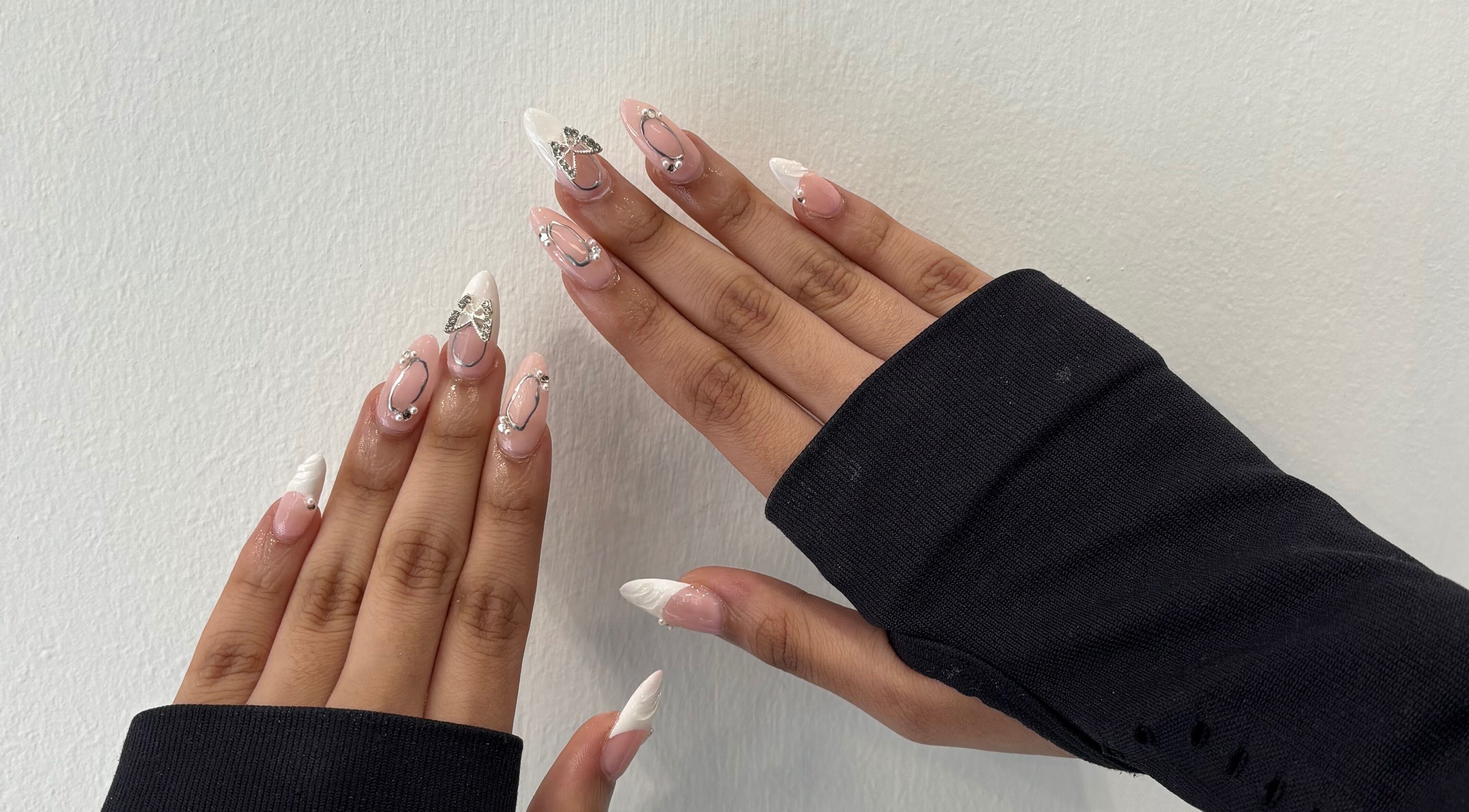 Elegant nail art with white and silver accents at Blush Dundee, Dundee, Scotland, GB.