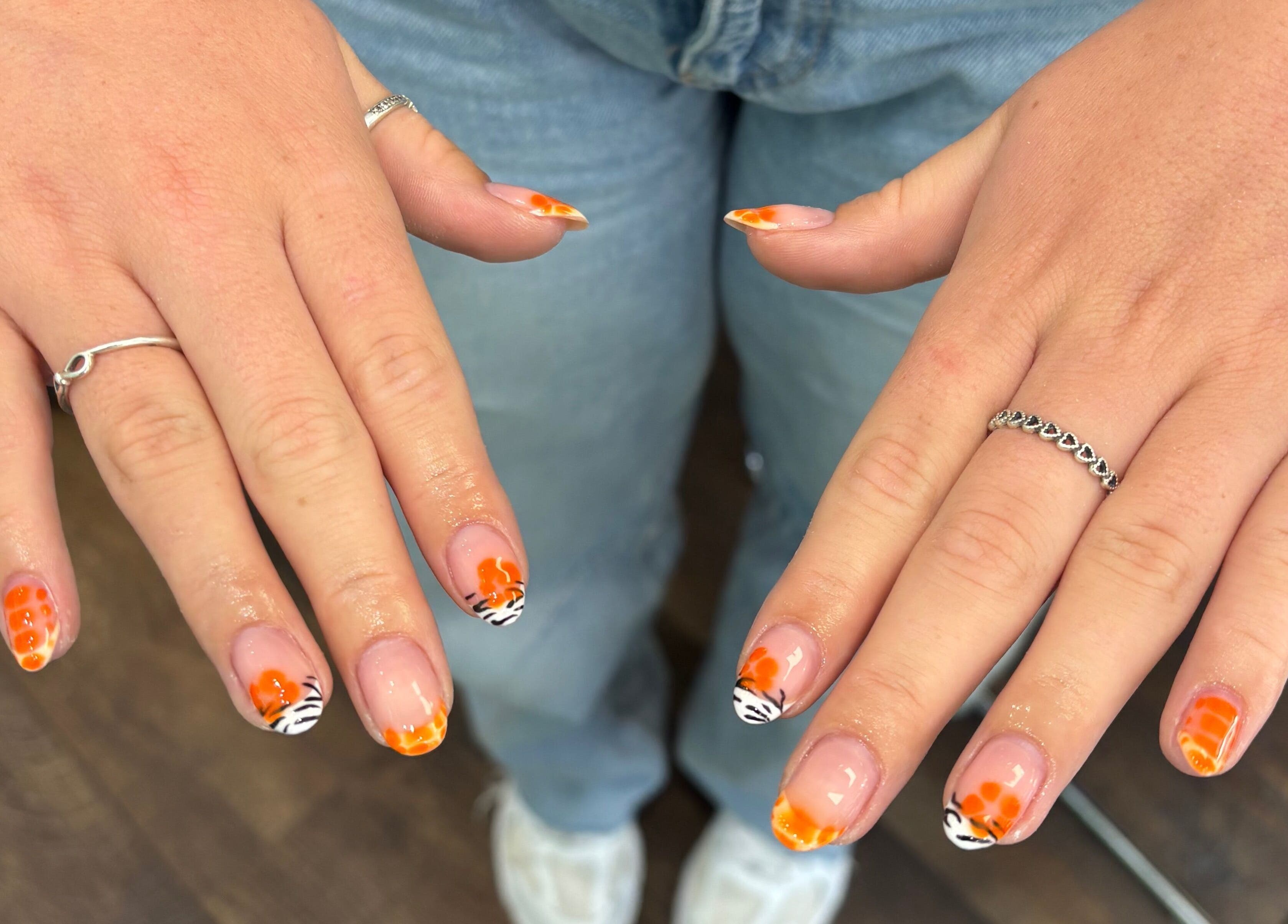 Colorful nail art at Blush Dundee, Dundee, Scotland, GB showcasing intricate zebra and orange designs.