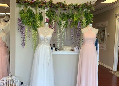 Chic bridal gowns on display at Best for Bride Barrie, Barrie, Ontario, CA with floral decor.