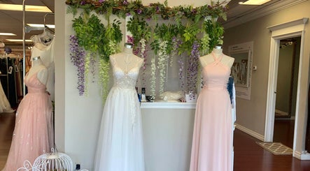 Chic bridal gowns on display at Best for Bride Barrie, Barrie, Ontario, CA with floral decor.