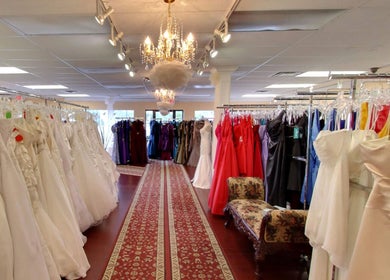 Elegant bridal gowns displayed at Best for Bride Barrie in Barrie, Ontario, CA, under a sparkling chandelier.