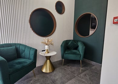 Chic lounge area with green chairs and decor at The Elenas Beauty Salon, Dubai, Dubai, AE.