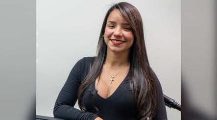 Smiling stylist at Africa Barber Girl, Montebello, California, US, ready to provide exceptional service.