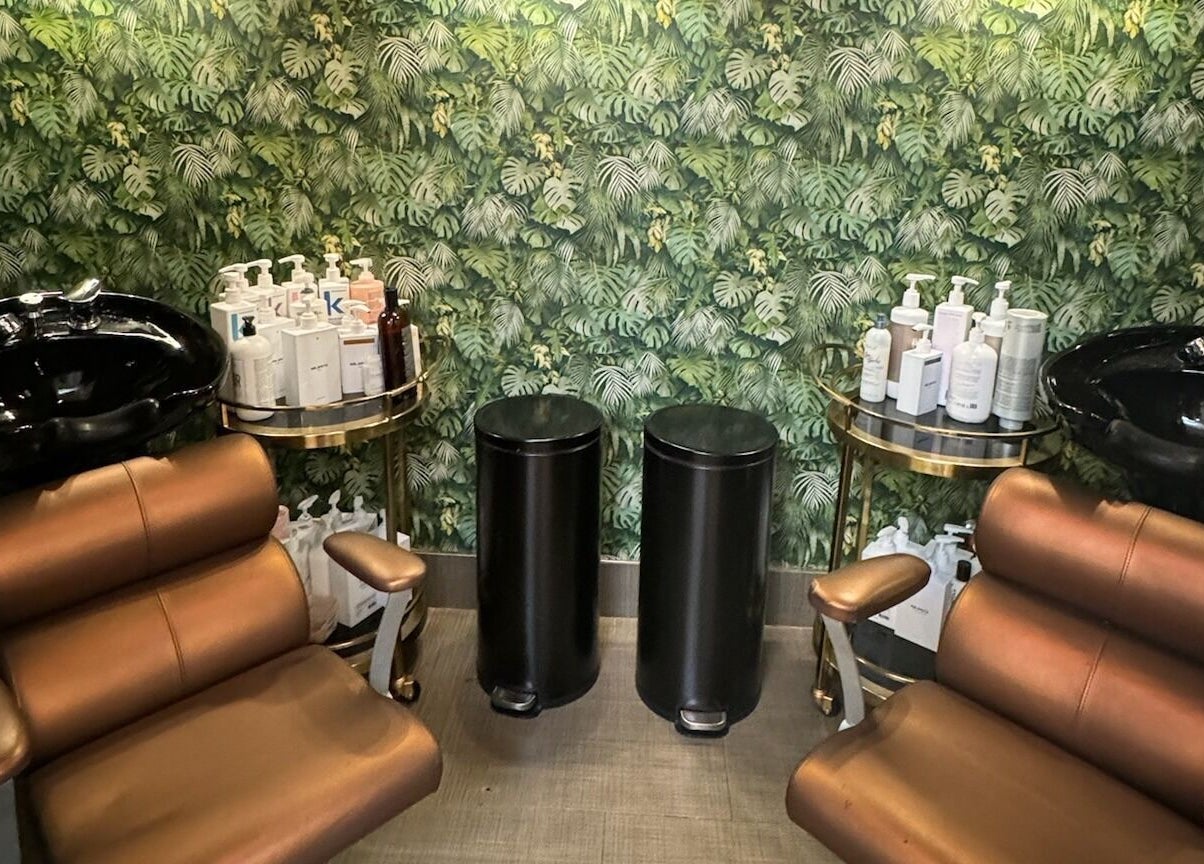 Luxurious salon chairs and foliage wall at Code Salon, San Francisco, California, US. Formerly Belles & Boheme.