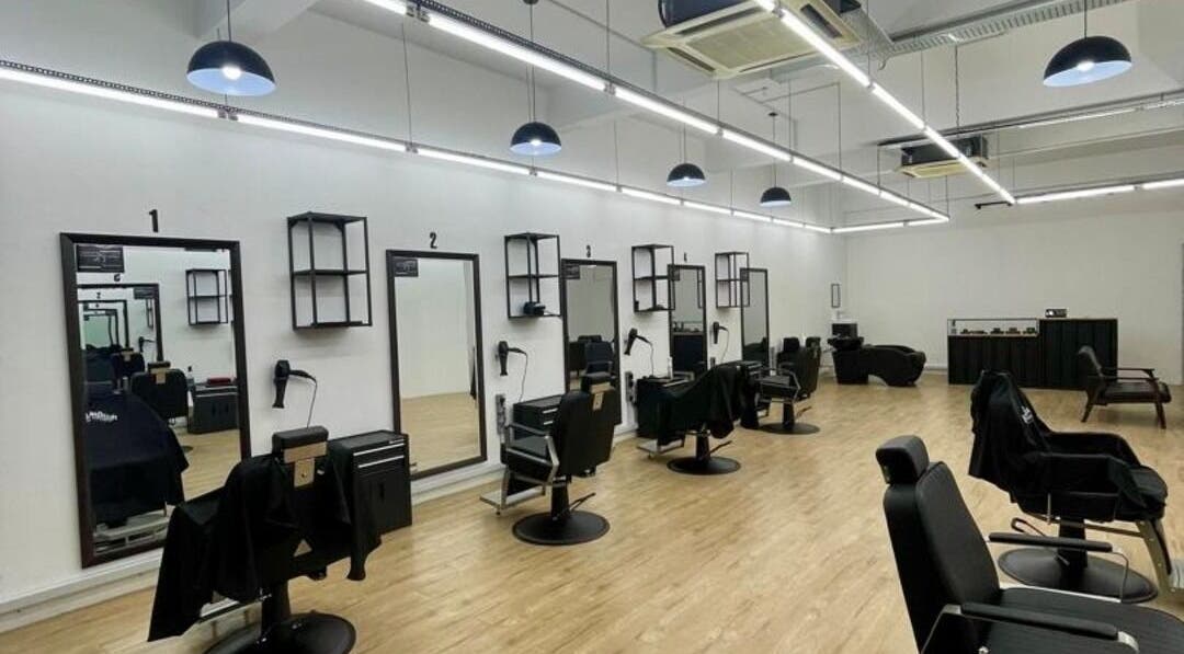 Modern interior of Bercutz Barbershop in Kuala Lumpur, featuring sleek styling stations and chairs.