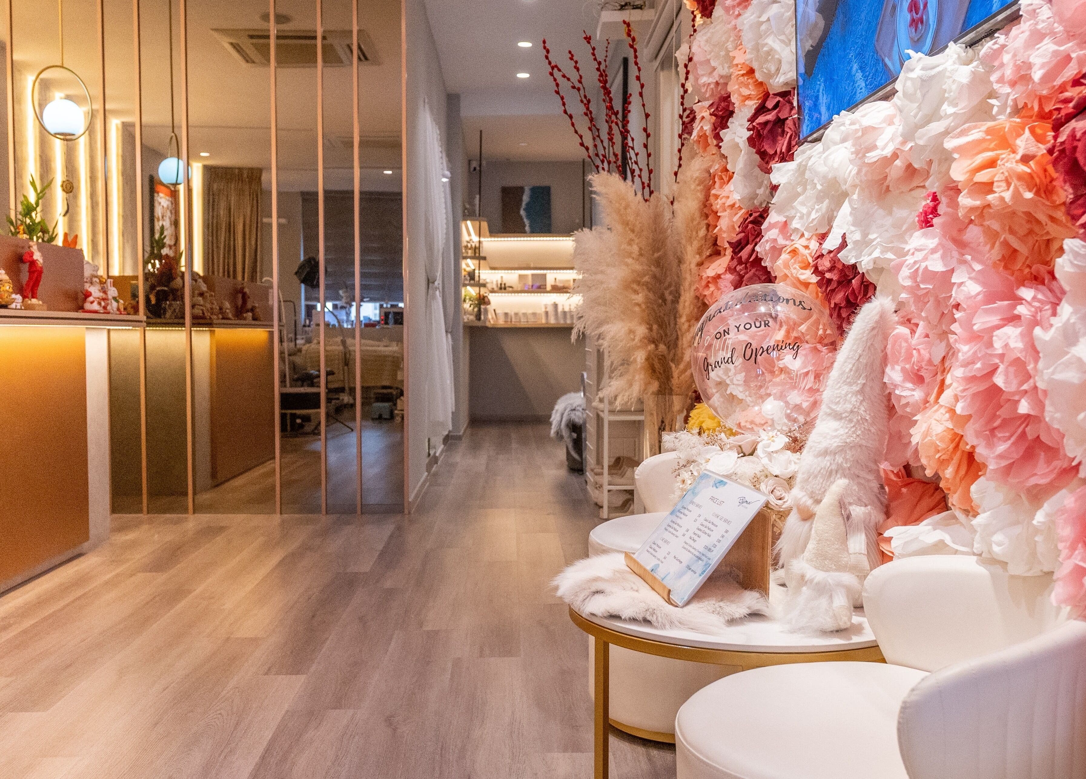 Elegant interior of Bijoux Nail Studio, Singapore, SG, with lush floral decor and modern furnishings.