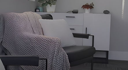Comfortable chair with throw at Divine Contours Studio, Citrus Heights, California, US.