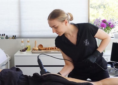 Aesthetician at Divine Contours Studio in Citrus Heights, California performing a beauty treatment.