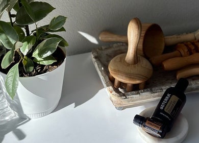 Calming spa setup at Divine Contours Studio in Citrus Heights, California, US with essential oils and greenery.