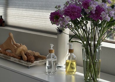 Elegant flower arrangement and spa tools at Divine Contours Studio, Citrus Heights, California, US.