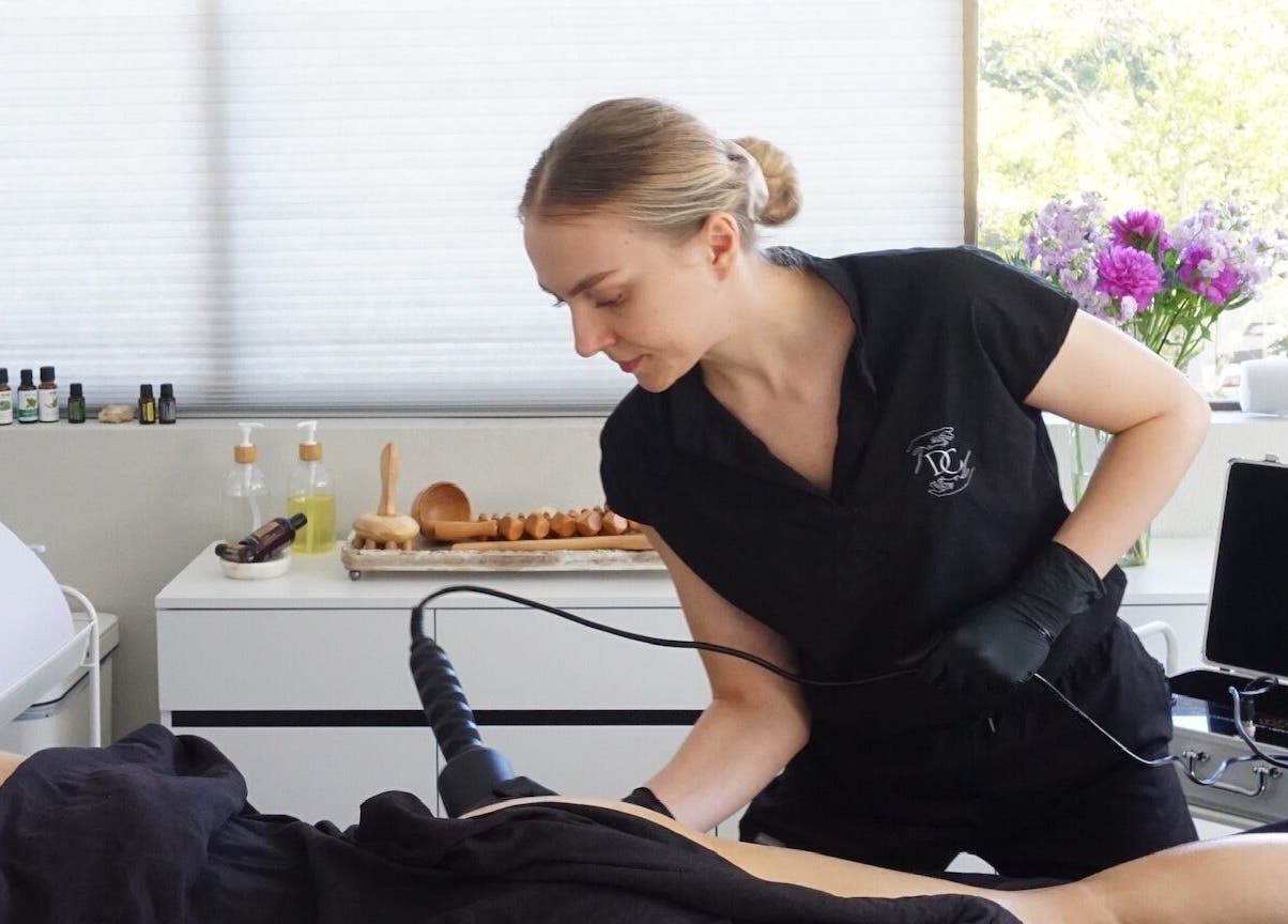 Therapist performing treatment at Divine Contours Studio in Citrus Heights, California, US.