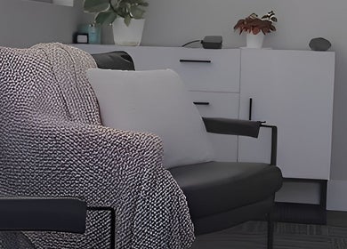 Elegant lounge chair with a textured throw at Divine Contours Studio, Citrus Heights, California, US.
