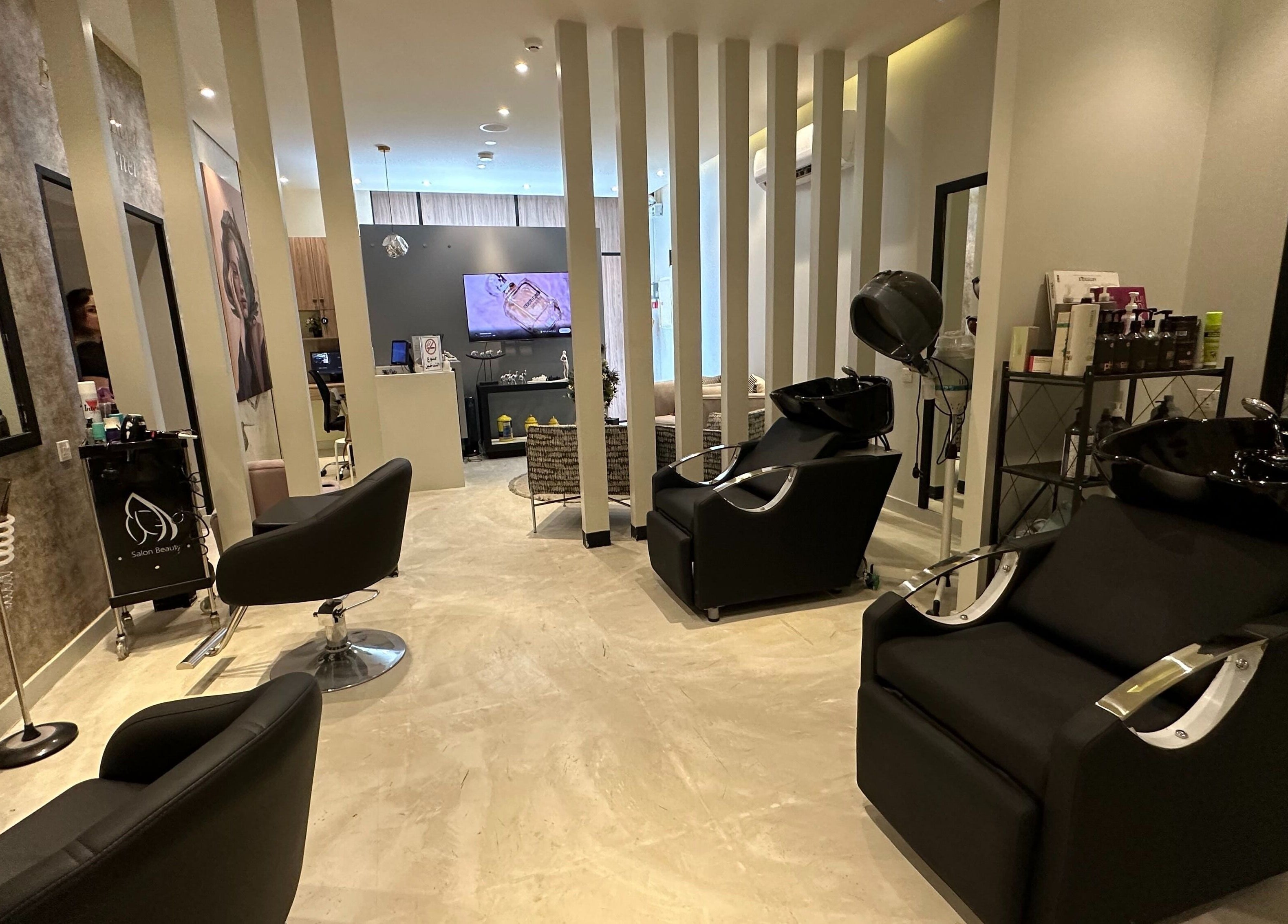 Modern interior of Purple Nail Spa Alyasmin in Riyadh, Riyadh Province, SA, featuring sleek styling chairs and decor.