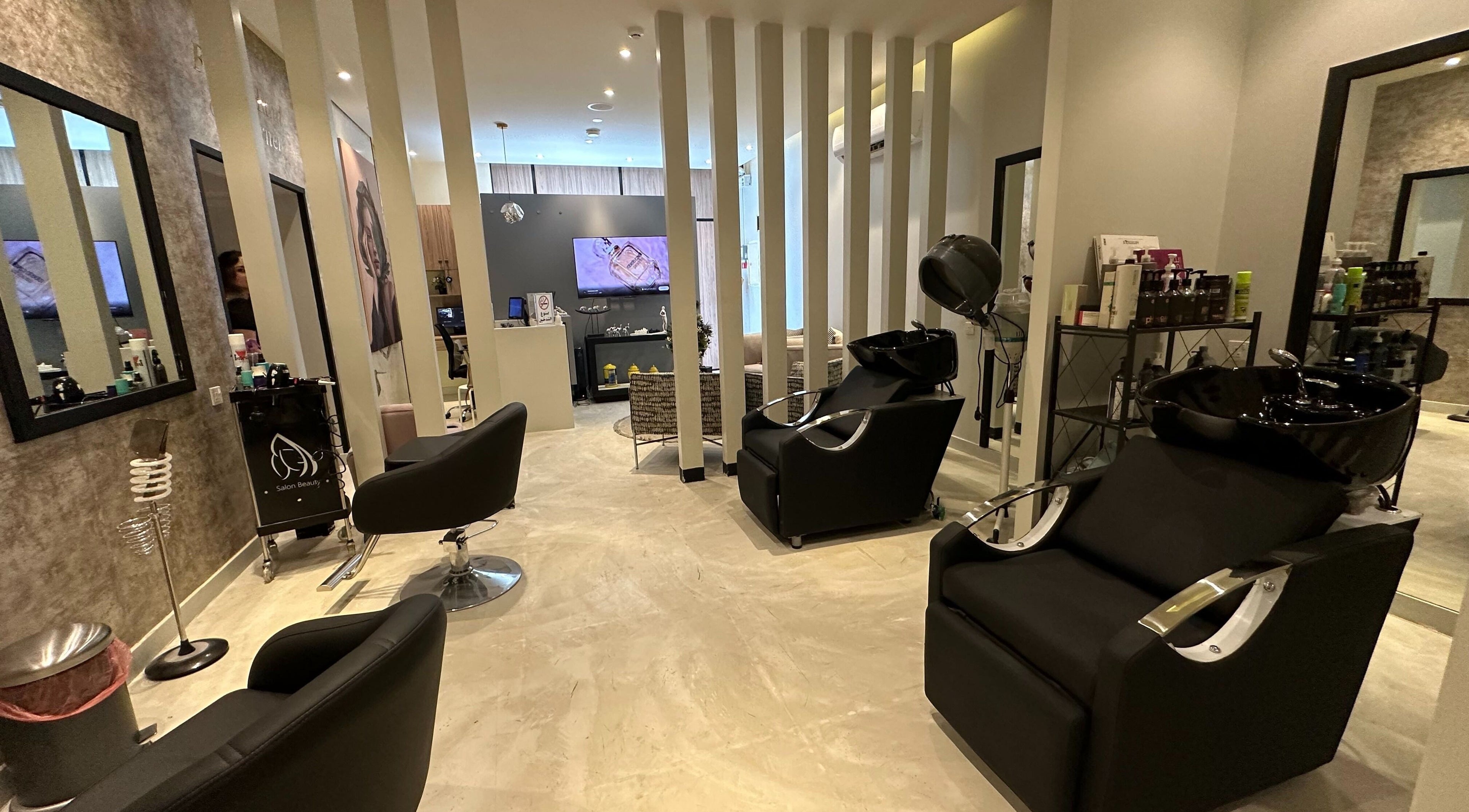 Modern interior of Purple Nail Spa Alyasmin in Riyadh, Riyadh Province, SA, featuring sleek styling chairs and decor.