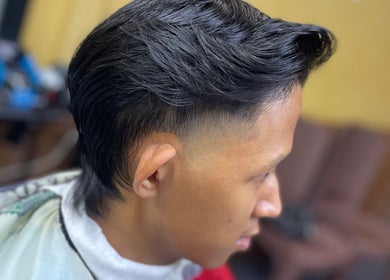 Close-up of a sleek fade haircut at Eden Barber, Ulu Tiram, Johor, MY showcasing expert styling.