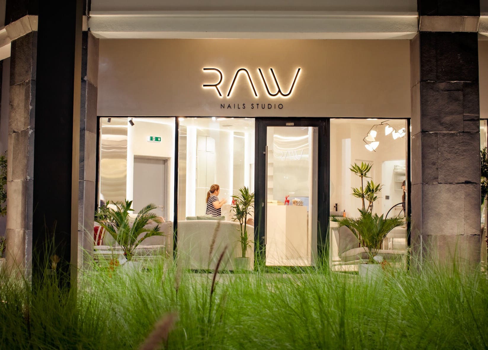 Front view of Raw Nails Studio with illuminated sign, located in دبي, دبي, AE.