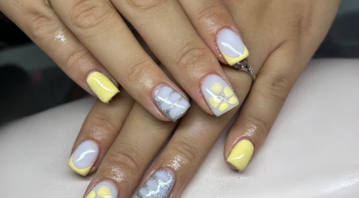 Beautiful floral nail art design at Kctnailz in Buckley, Wales, GB, featuring yellow accents.