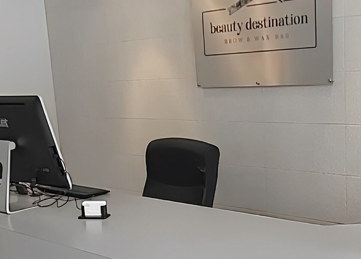 Reception area at Beauty Destination Brow and Wax Bar, Burlington, Ontario, CA featuring modern decor and signage.