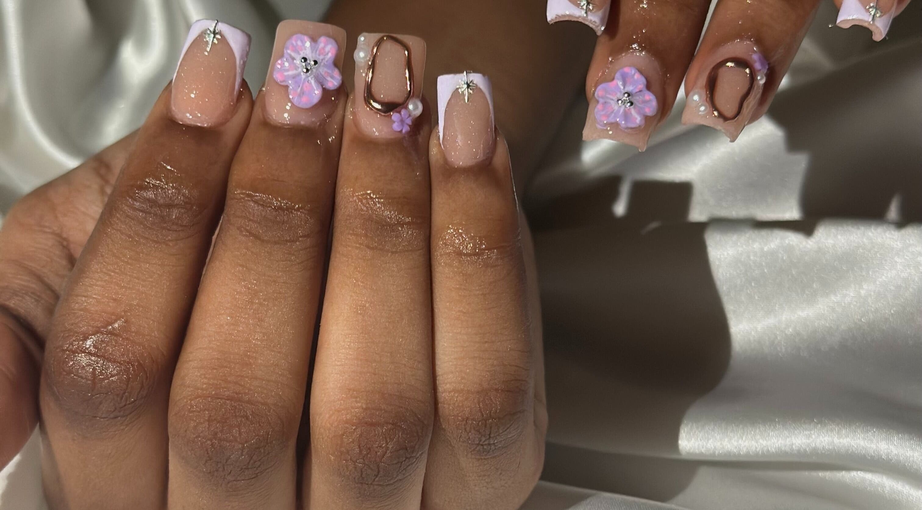 Elegant floral nail art at The Nail Vanity, Montego Bay, St. James Parish, JM, showcasing 3D flowers and gems.