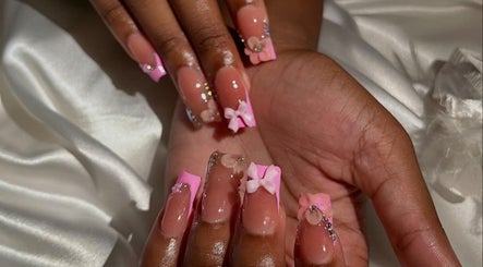 Stylish pink nails with bows at The Nail Vanity, Montego Bay, St. James Parish, JM.