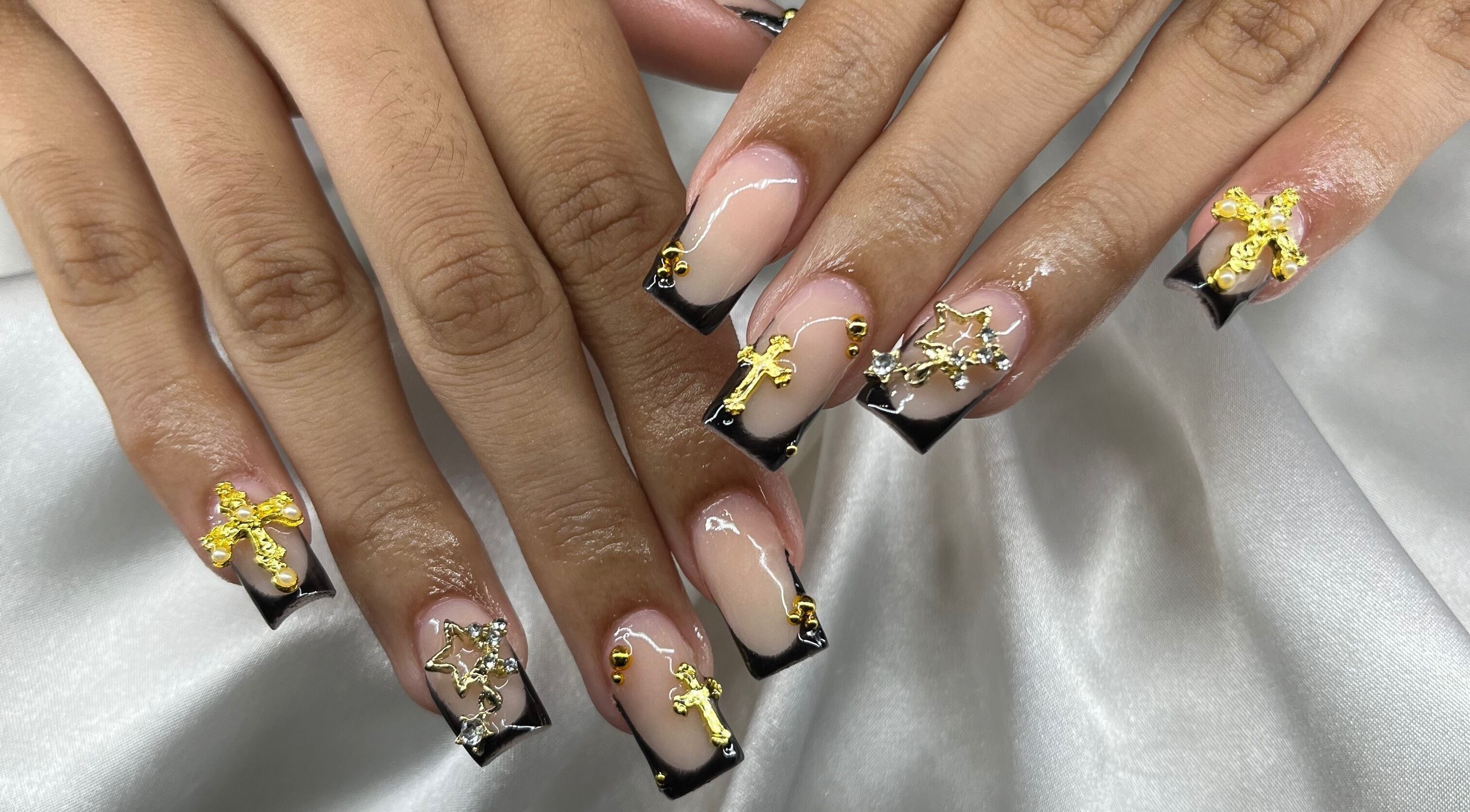 Intricate nail art design with gold embellishments at The Nail Vanity, Montego Bay, St. James Parish, JM.