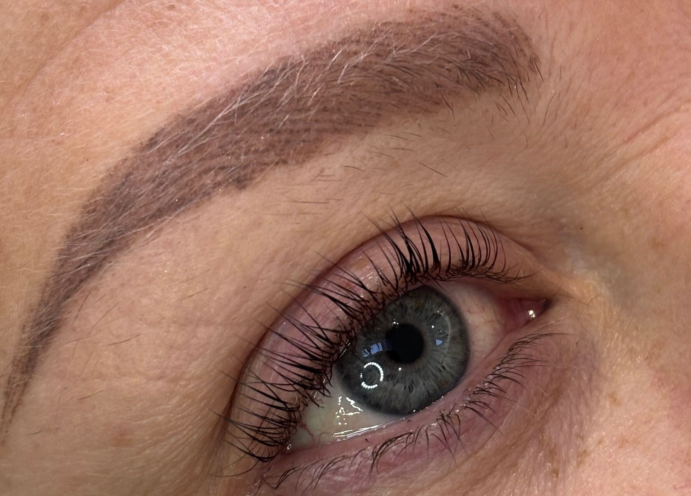 Close-up of expertly shaped eyebrow at Glam by Tyler Marie, Oswestry, England, GB, showcasing microblading detail.