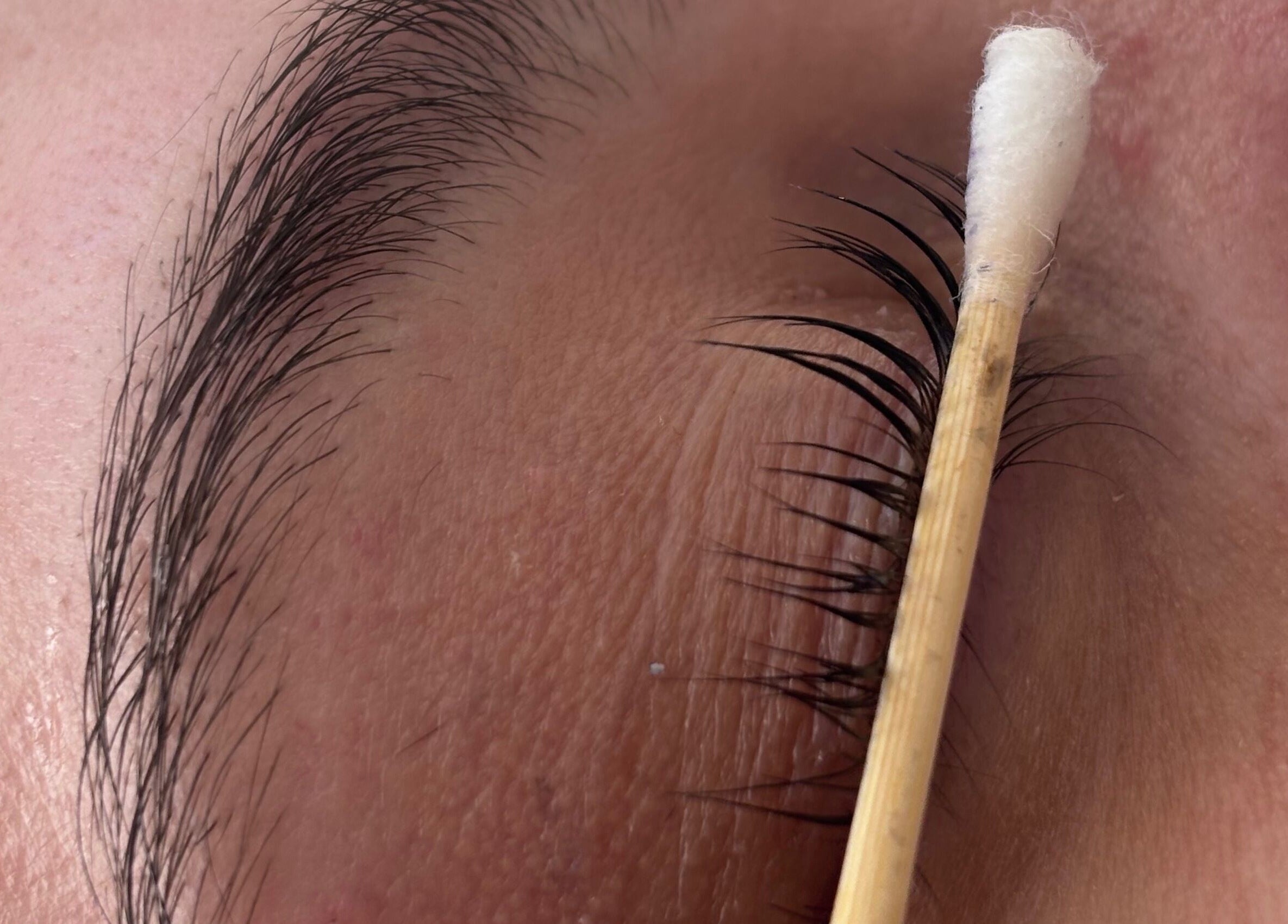 Close-up of eyelash being groomed at Glam by Tyler Marie, Oswestry, England, GB.