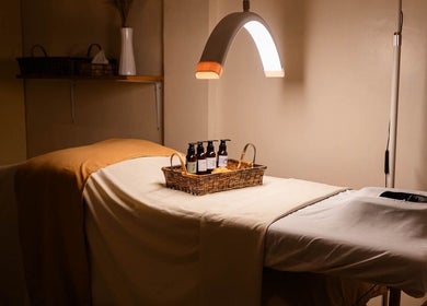 Tranquil massage room at Elle. Massage Therapy & Wellness Iloilo, Iloilo City, PH, with oils on table.