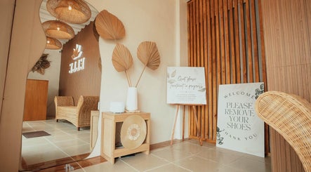 Calm entryway at Elle. Massage Therapy & Wellness Iloilo, Iloilo City, PH with rattan furniture and decor.