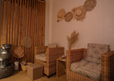 Elegant lounge area at Elle. Massage Therapy & Wellness Iloilo, featuring wicker chairs in Iloilo City, PH.
