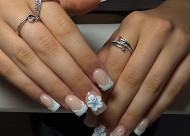 Elegant floral nail art at The Beauty Lounge, Swindon, England, GB, showcasing intricate blue designs.